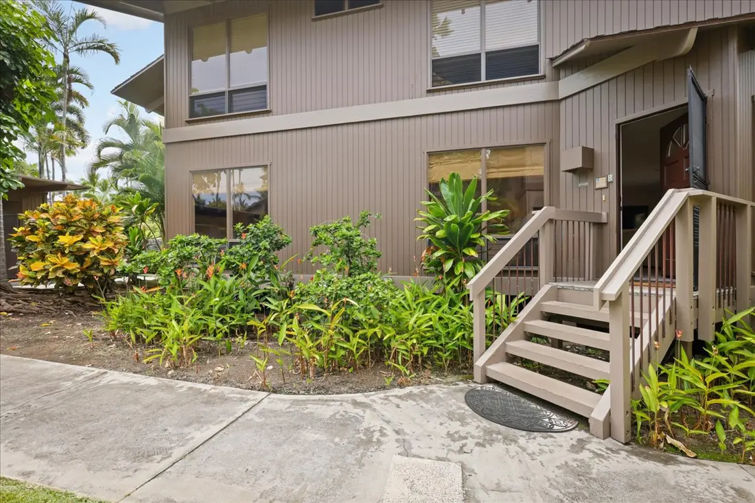 Exterior entrance surrounded by tropical landscaping