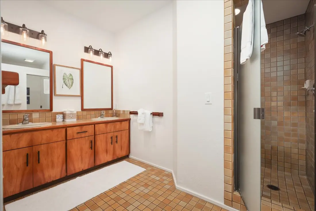 Primary ensuite bathroom with dual vanity and walk-in shower