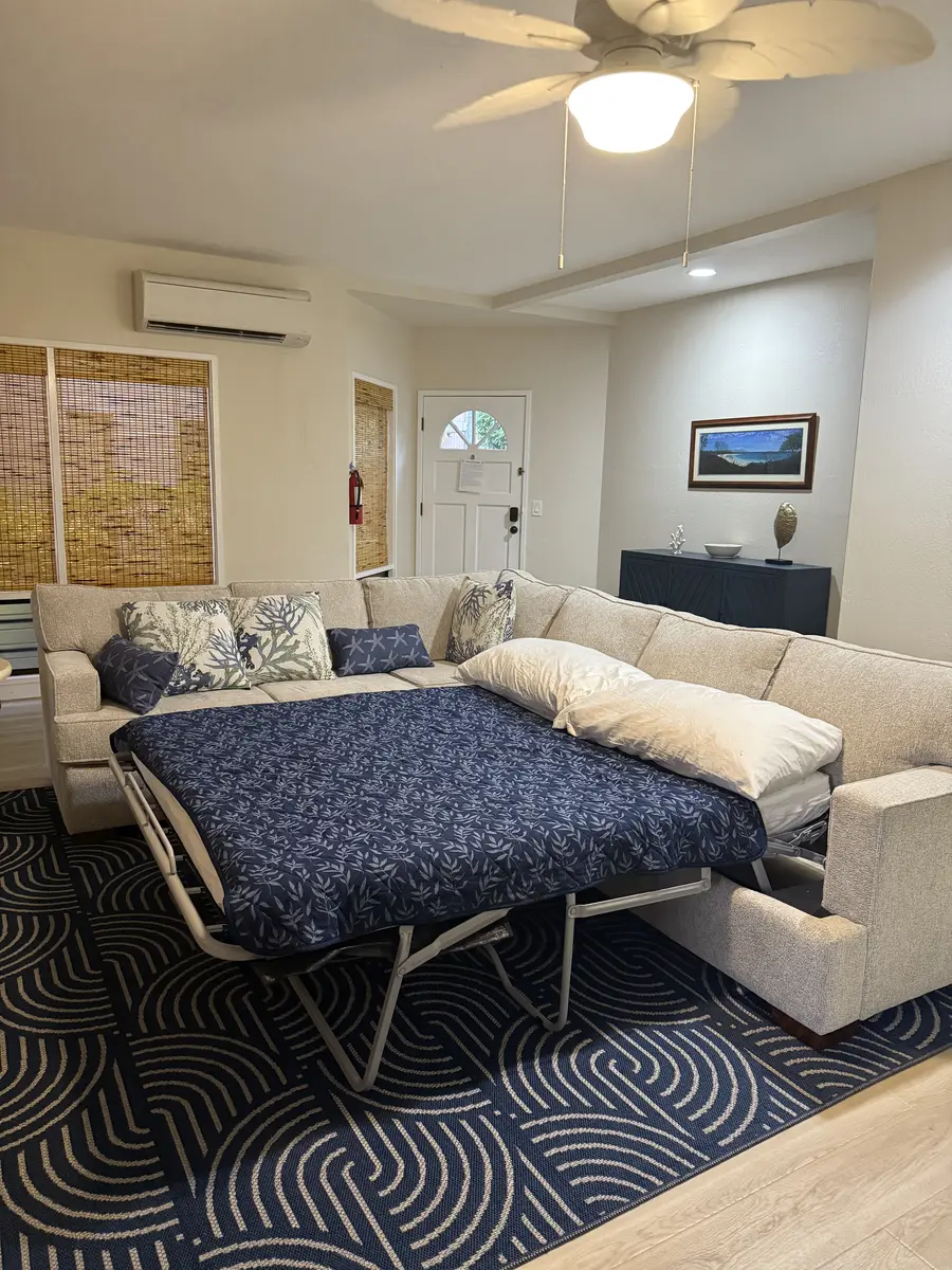 Queen sleeper sofa set up with bedding