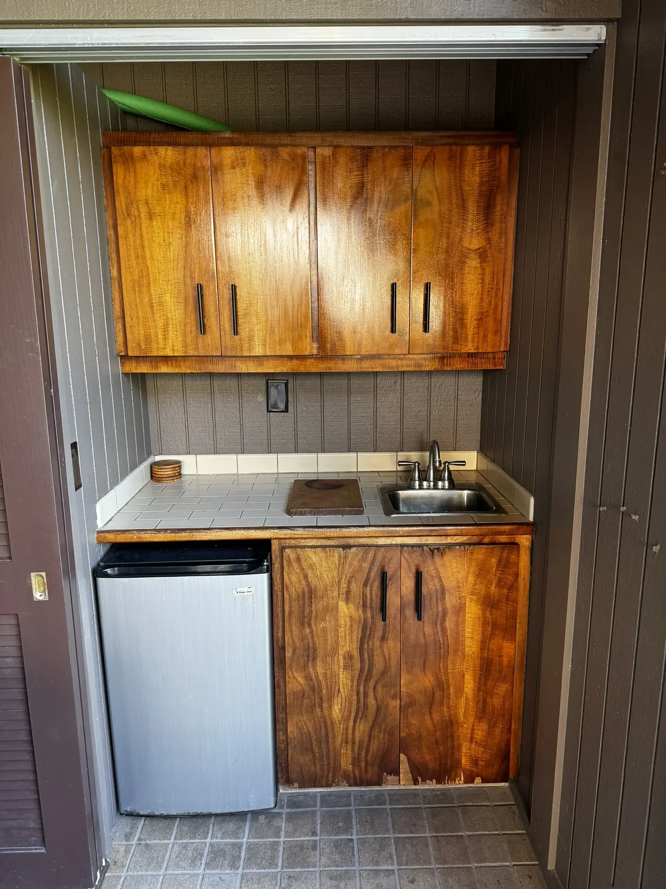 Lanai wet bar with sink, cabinets and mini refrigerator
