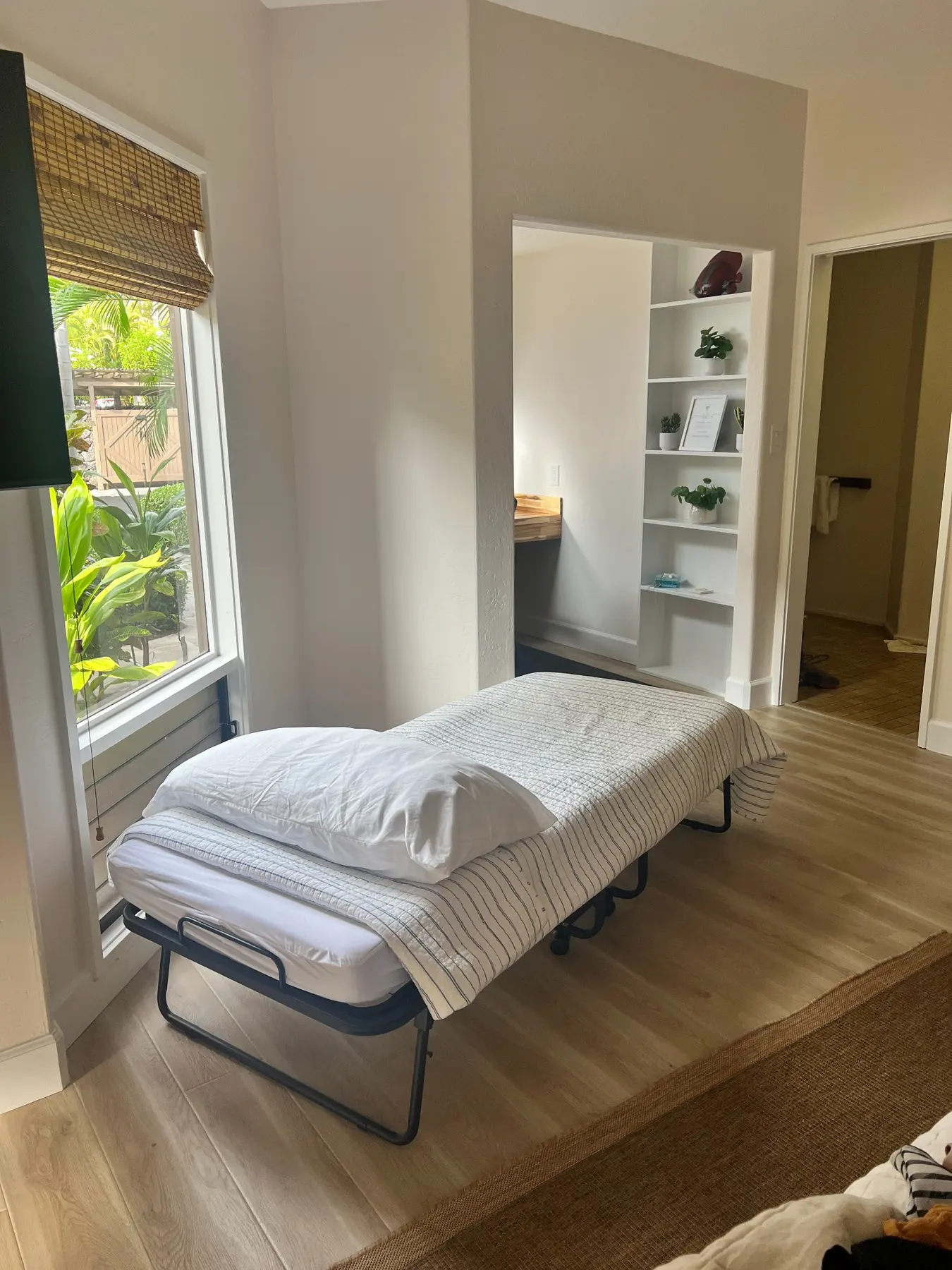 Toddler cot set up in a bright bedroom